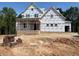 Unfinished two-story house exterior with a porch and garage at 332 Inspiration Way, Fuquay Varina, NC 27526