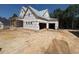 Unfinished two-story home with a three-car garage at 332 Inspiration Way, Fuquay Varina, NC 27526