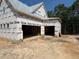 Unfinished three-car garage attached to a two story house at 332 Inspiration Way, Fuquay Varina, NC 27526