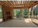 Unfinished sunroom with a fireplace and an outdoor view of the wooded back yard at 332 Inspiration Way, Fuquay Varina, NC 27526