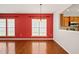 Dining room features hardwood floors, modern chandelier, and view into the kitchen at 340 Orbison Dr, Cary, NC 27519
