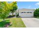 Inviting home with a well-maintained lawn, mature tree, and a two-car garage at 340 Orbison Dr, Cary, NC 27519