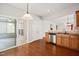 Kitchen area with stainless steel dishwasher, sink and access to sunroom at 340 Orbison Dr, Cary, NC 27519