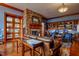 Cozy lounge area with stone fireplace, comfortable leather seating, and custom wood bookshelves at 340 Orbison Dr, Cary, NC 27519