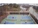 Aerial view of pickleball courts with players, showcasing the community's active lifestyle amenities at 340 Orbison Dr, Cary, NC 27519