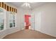 Versatile room showcasing double doors, neutral carpet, and a sunlit bay window at 340 Orbison Dr, Cary, NC 27519