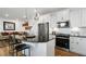 Modern kitchen features granite counters, stainless steel appliances, and white cabinetry with eat in bar at 352 Church St # 53, Wendell, NC 27591