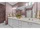 Elegant bathroom with a double vanity, decorative mirror, and sophisticated wallpaper at 3923 Napa Valley Dr, Raleigh, NC 27612