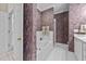Stylish bathroom with a soaking tub, walk-in shower, and elegant wall treatment at 3923 Napa Valley Dr, Raleigh, NC 27612