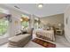 Bright bedroom with large windows, a cozy chaise lounge, and a comfortable bed at 3923 Napa Valley Dr, Raleigh, NC 27612