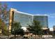 The modern glass exterior of the UNC Rex building framed by mature trees at 3923 Napa Valley Dr, Raleigh, NC 27612