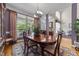 Cozy dining room offering a view of the front porch, hardwood floors, and decorative chandelier at 3923 Napa Valley Dr, Raleigh, NC 27612