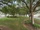 A peaceful, tree-lined street and yard, showing the beautiful landscape and nearby homes at 3923 Napa Valley Dr, Raleigh, NC 27612