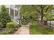 Charming two-story home with a covered front porch, red front door, landscaped yard, and brick and siding exterior at 3923 Napa Valley Dr, Raleigh, NC 27612