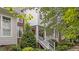 Charming two-story home with a front porch, red front door, landscaped yard, and brick and siding exterior at 3923 Napa Valley Dr, Raleigh, NC 27612