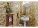 Charming half bathroom with floral wallpaper, pedestal sink, and decorative accents at 3923 Napa Valley Dr, Raleigh, NC 27612