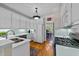 Well-lit kitchen features a breakfast bar, white cabinets, and modern appliances at 3923 Napa Valley Dr, Raleigh, NC 27612