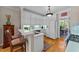 Charming kitchen features white cabinets, a breakfast bar, and hardwood floors at 3923 Napa Valley Dr, Raleigh, NC 27612