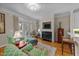 Cozy living room with fireplace, built-in shelving, and access to the outdoor patio through glass doors at 3923 Napa Valley Dr, Raleigh, NC 27612