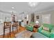 Open living space showcasing kitchen access with barstool seating and views of the staircase at 3923 Napa Valley Dr, Raleigh, NC 27612