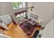 An elevated view of a beautifully staged living room with fireplace and soaring ceilings at 3923 Napa Valley Dr, Raleigh, NC 27612