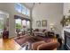 Light-filled living room with tall windows, a plush sofa, and a striking area rug at 3923 Napa Valley Dr, Raleigh, NC 27612
