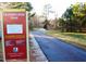 Crabtree Creek Trail, a paved trail surrounded by a forest with a walking trail sign at 3923 Napa Valley Dr, Raleigh, NC 27612
