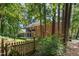 A brick home with a screened in porch and a fenced in yard with mature trees at 4020 Gumleaf Dr, Apex, NC 27539