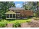 An inviting brick home featuring a screened porch, outdoor patio, and a beautiful lawn at 4020 Gumleaf Dr, Apex, NC 27539