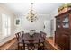 Elegant dining room with a large table, chandelier, and traditional decor at 4020 Gumleaf Dr, Apex, NC 27539