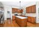 Charming kitchen featuring wooden cabinets, center island, and stainless steel appliances at 4020 Gumleaf Dr, Apex, NC 27539