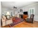 Inviting living room featuring a fireplace, hardwood floors, and comfortable seating at 4020 Gumleaf Dr, Apex, NC 27539