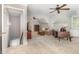 An expansive living room features plush seating, a ceiling fan, and a nearby staircase at 4020 Gumleaf Dr, Apex, NC 27539