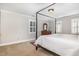 A neutral main bedroom has a four-poster bed, carpeted floors, and shuttered windows at 4020 Gumleaf Dr, Apex, NC 27539