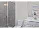 Clean bathroom featuring a tiled shower, toilet, and a single sink vanity with white countertop at 408 Longleaf Glen Lane, Zebulon, NC 27597