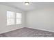 Unfurnished bedroom with neutral carpet and double windows, creating a bright and adaptable living space at 408 Longleaf Glen Lane, Zebulon, NC 27597