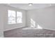 Light-filled bedroom with double windows and neutral carpet, showcasing a cozy and inviting atmosphere at 408 Longleaf Glen Lane, Zebulon, NC 27597