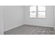 Empty bedroom with neutral carpet, a double window, and fresh white paint at 408 Longleaf Glen Lane, Zebulon, NC 27597