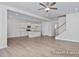 Spacious living room featuring an open floor plan, modern lighting, and staircase to the upper level at 408 Longleaf Glen Lane, Zebulon, NC 27597