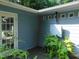Back deck area shows the gray home's door, potted plants, and a water heater at 4144 Fairport Rd, Kittrell, NC 27544