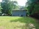 Exterior of home showcasing large, lush backyard with mature trees on an expansive lot at 4144 Fairport Rd, Kittrell, NC 27544