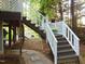 Staircase leading to elevated outdoor space with decorative railings and greenery at 4144 Fairport Rd, Kittrell, NC 27544
