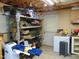 Unfinished basement features storage shelves, concrete floor, and door to the exterior at 4144 Fairport Rd, Kittrell, NC 27544