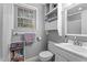 Cozy bathroom featuring neutral colors, shelving, and a bright window at 4144 Fairport Rd, Kittrell, NC 27544