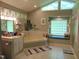 Large bathroom with jacuzzi tub, glass block window, and shower stall at 4144 Fairport Rd, Kittrell, NC 27544