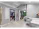 Bathroom boasting walk-in closet, tiled floors, and view into the bedroom and vaulted ceilings at 4144 Fairport Rd, Kittrell, NC 27544