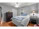 Comfortable bedroom with wood floors, ceiling fan, closet, and large dresser at 4144 Fairport Rd, Kittrell, NC 27544
