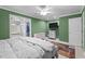 Large primary bedroom featuring ceiling fan, adjacent closet, and a TV at 4144 Fairport Rd, Kittrell, NC 27544