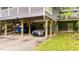 Covered carport with space for two vehicles and boat storage, and under-house access at 4144 Fairport Rd, Kittrell, NC 27544