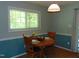 This charming dining area features hardwood floors, a round table, and a window providing natural light at 4144 Fairport Rd, Kittrell, NC 27544
